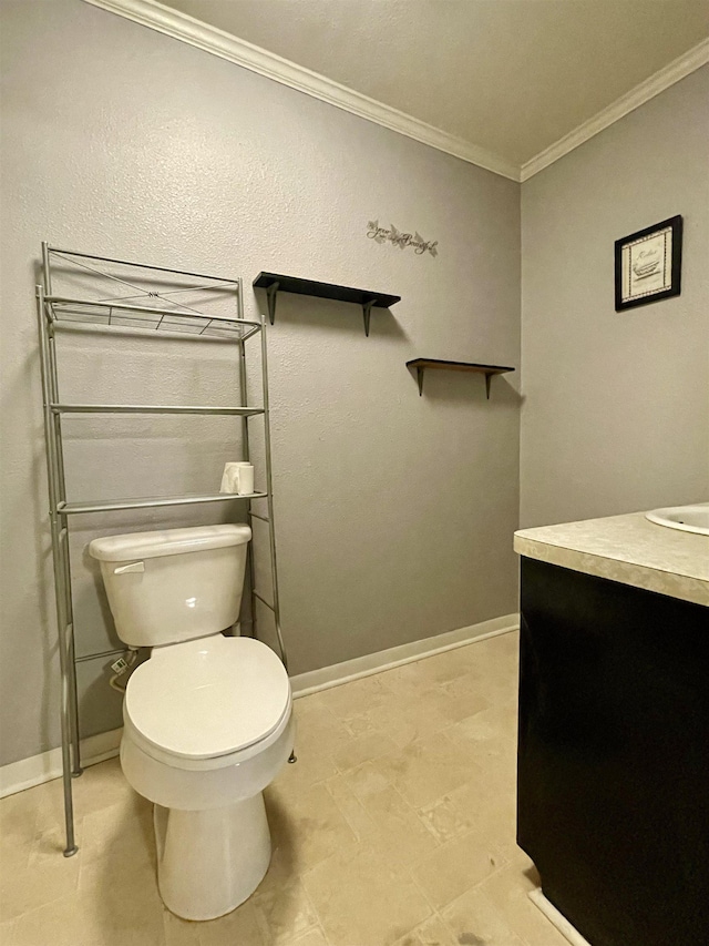 bathroom featuring vanity, toilet, and crown molding