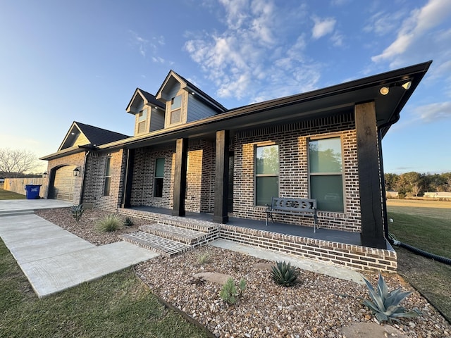 view of front of house with a porch and a garage