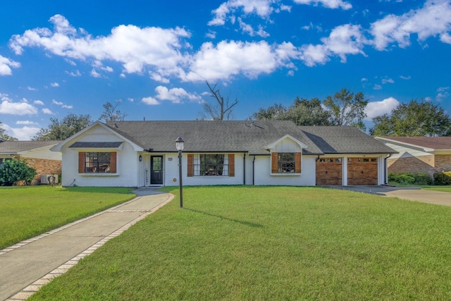 ranch-style home featuring a front lawn and a garage