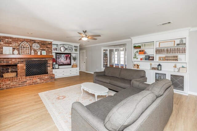 4910 Gladys Ave, Beaumont, TX 77706 - living area featuring crown molding, a fireplace, wood finished floors, and visible vents