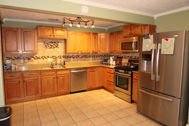 kitchen with backsplash, sink, ornamental molding, light stone counters, and stainless steel appliances