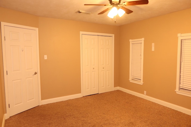 unfurnished bedroom with ceiling fan and carpet