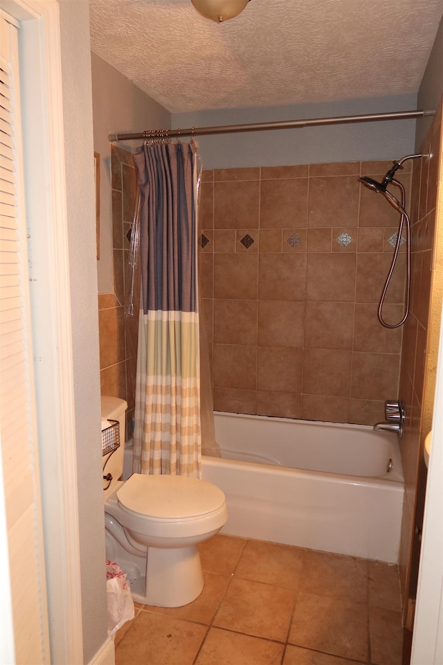 bathroom featuring tile patterned flooring, a textured ceiling, toilet, and shower / bath combo with shower curtain