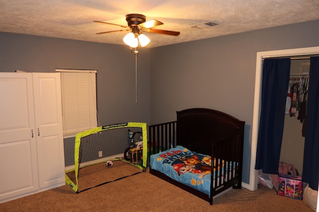 bedroom featuring ceiling fan, carpet, and a textured ceiling