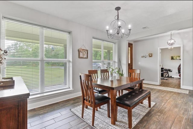 dining space with baseboards, light wood-type flooring, and an inviting chandelier