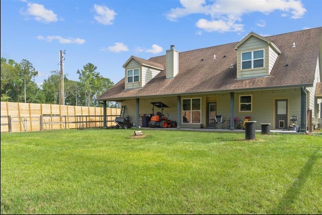 rear view of house featuring a yard, a patio, a shingled roof, central AC, and fence