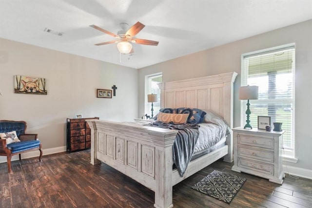 bedroom featuring ceiling fan, dark wood-type flooring, visible vents, and baseboards