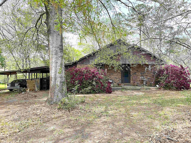 view of side of home with a carport and brick siding