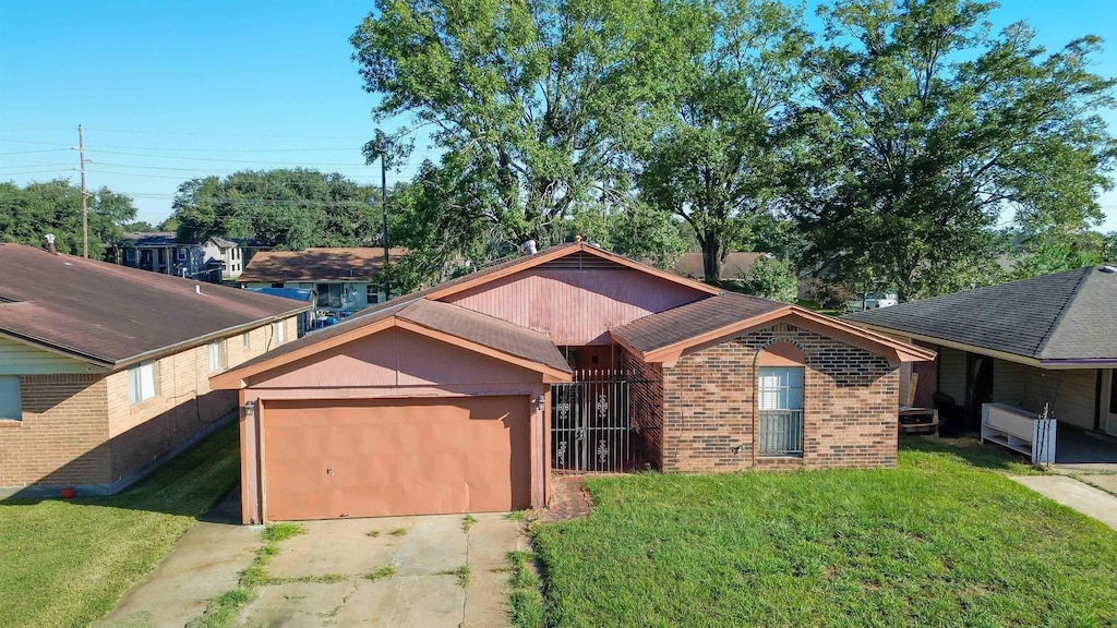 view of front of property with a front yard and a garage