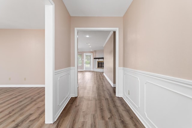 hall with ornamental molding and hardwood / wood-style flooring