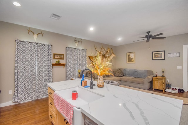 2000 Aggie Dr, Beaumont, TX 77713 - kitchen with light wood-type flooring, a ceiling fan, recessed lighting, open floor plan, and light stone counters
