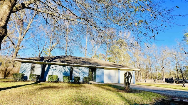 ranch-style house featuring a garage and a front yard