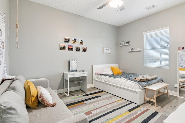 bedroom featuring ceiling fan and light hardwood / wood-style flooring