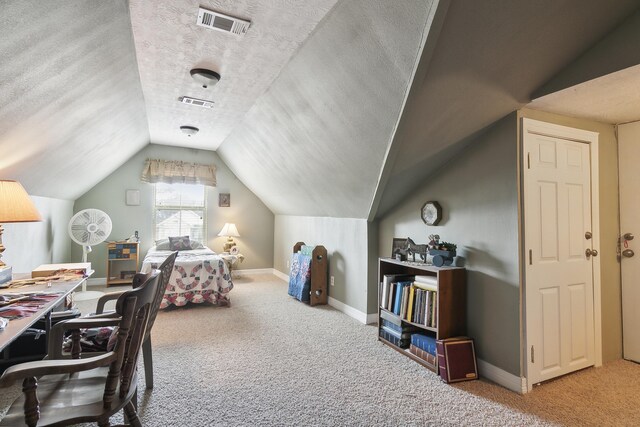 bedroom featuring carpet, lofted ceiling, and a textured ceiling