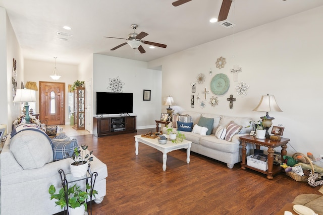 living room featuring ceiling fan and dark hardwood / wood-style flooring