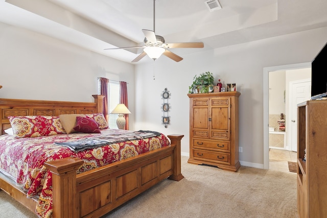 bedroom with connected bathroom, ceiling fan, and light colored carpet