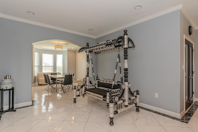 exercise area featuring marble finish floor, baseboards, arched walkways, and ornamental molding