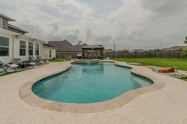 view of swimming pool with a patio area, a fenced backyard, a pool with connected hot tub, and a lawn