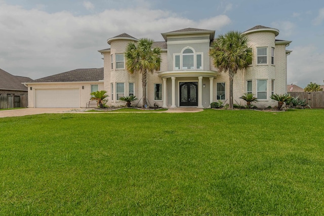 view of front of home featuring concrete driveway, an attached garage, fence, french doors, and a front yard