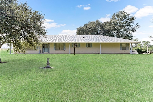 3030 Moore Rd, Beaumont, TX 77713 - rear view of house with a metal roof and a yard