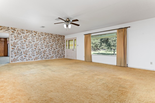 3030 Moore Rd, Beaumont, TX 77713 - unfurnished room featuring carpet, ceiling fan, and wallpapered walls
