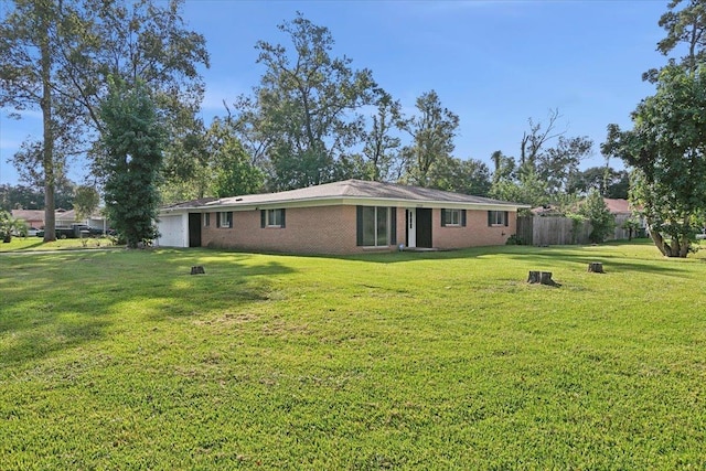 back of property featuring a yard