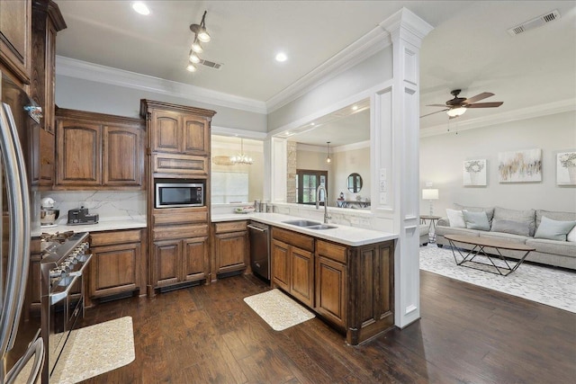 kitchen with a sink, open floor plan, light countertops, appliances with stainless steel finishes, and visible vents