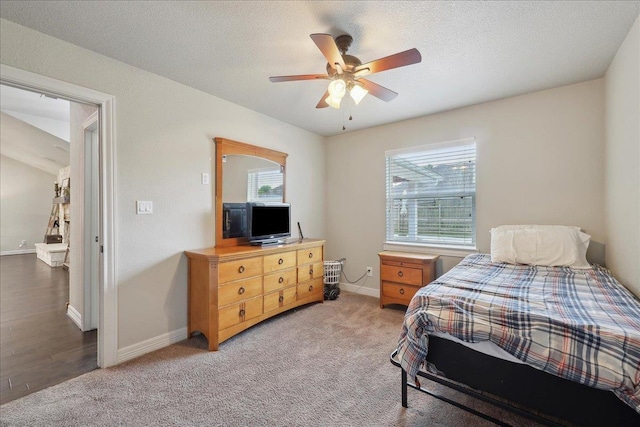 bedroom with light carpet, baseboards, and ceiling fan