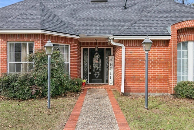 doorway to property featuring a lawn