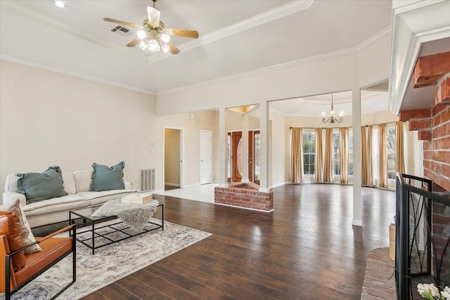 living room featuring ceiling fan with notable chandelier, hardwood / wood-style floors, ornamental molding, and a tray ceiling