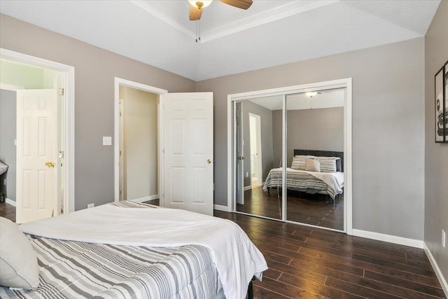 bedroom featuring ceiling fan, ornamental molding, a closet, and a raised ceiling