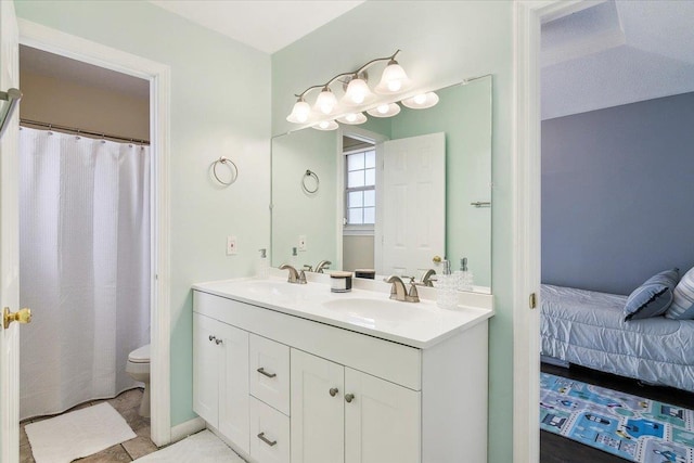 bathroom with tile patterned flooring, vanity, and toilet