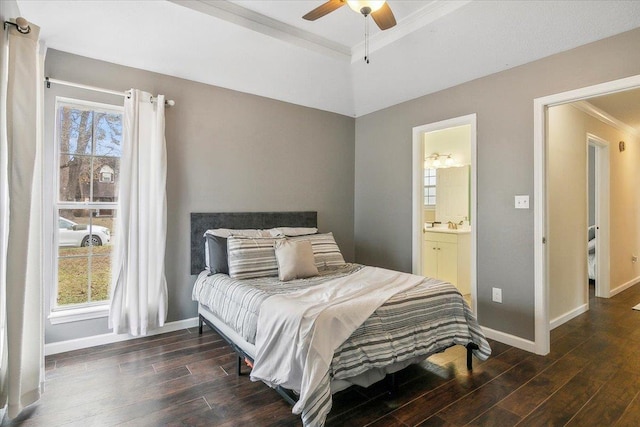 bedroom with dark hardwood / wood-style flooring, multiple windows, ceiling fan, and a raised ceiling