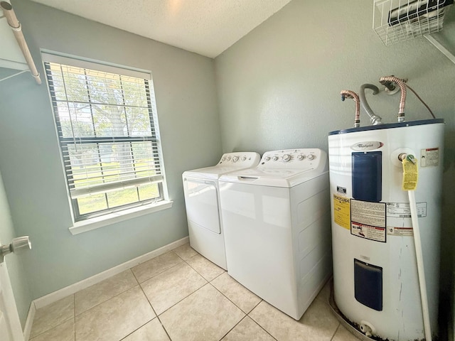 857 Sharp St, Bridge City, TX 77611 - laundry area featuring water heater, washer and clothes dryer, a textured ceiling, and light tile patterned flooring