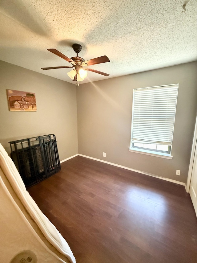 857 Sharp St, Bridge City, TX 77611 - empty room featuring dark wood finished floors, a ceiling fan, and a textured ceiling