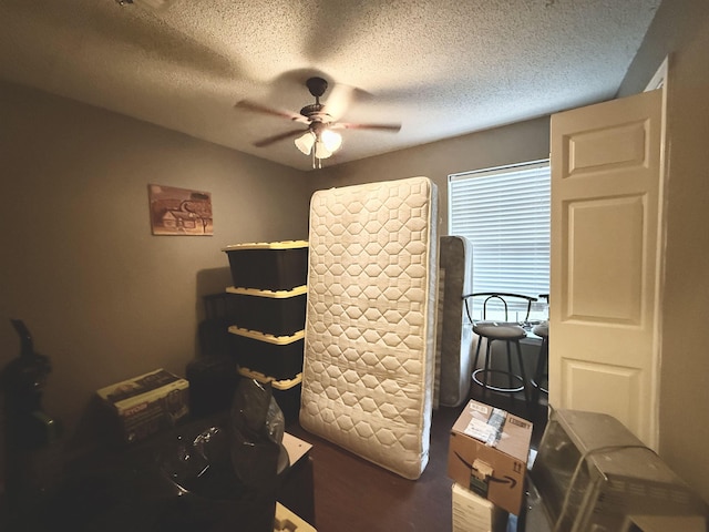 bedroom with a textured ceiling and ceiling fan