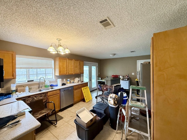 kitchen featuring visible vents, a notable chandelier, a sink, stainless steel dishwasher, and light countertops