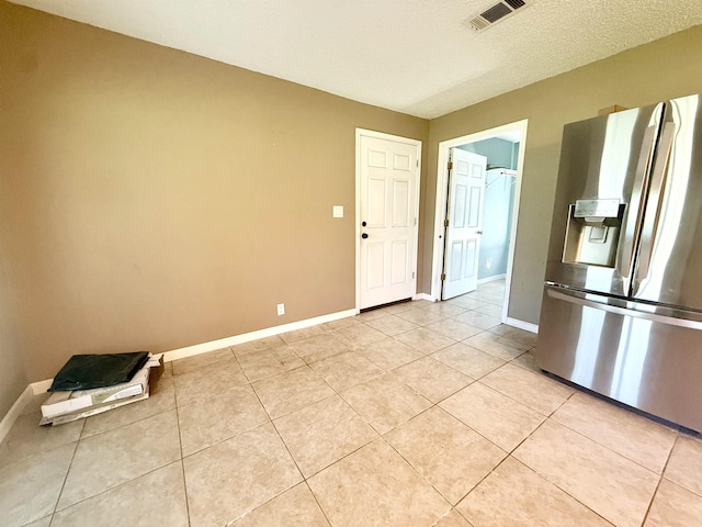 857 Sharp St, Bridge City, TX 77611 - kitchen featuring stainless steel fridge with ice dispenser and light tile patterned floors