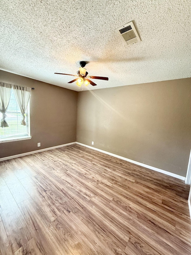 857 Sharp St, Bridge City, TX 77611 - spare room with ceiling fan, wood finished floors, and a textured ceiling