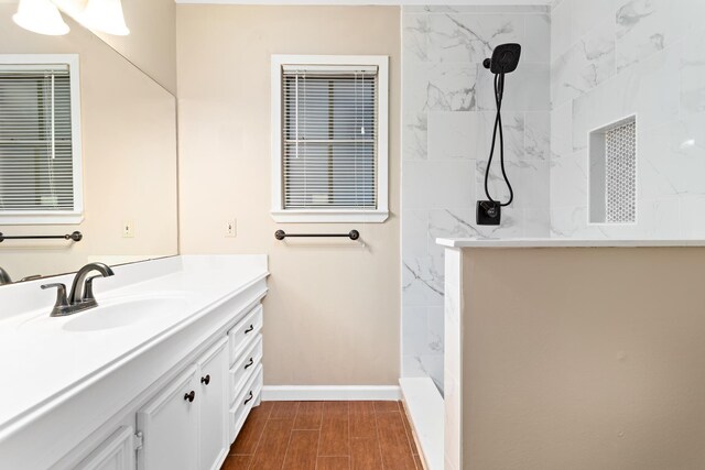 bathroom featuring vanity and tiled shower