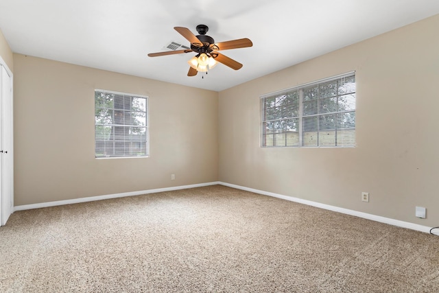 spare room featuring carpet and ceiling fan