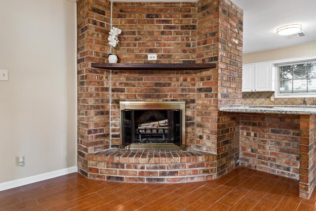 details with backsplash and a brick fireplace