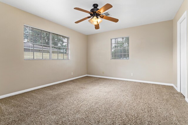 empty room featuring ceiling fan and carpet floors