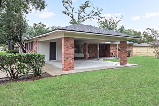 back of property featuring a yard and a patio area