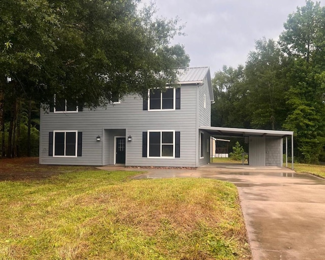 575 Hartman, Silsbee, TX 77656 - view of front facade with a carport, a front lawn, driveway, and a metal roof