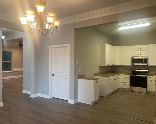 575 Hartman, Silsbee, TX 77656 - kitchen with appliances with stainless steel finishes, dark wood-type flooring, ceiling fan, a chandelier, and ornamental molding