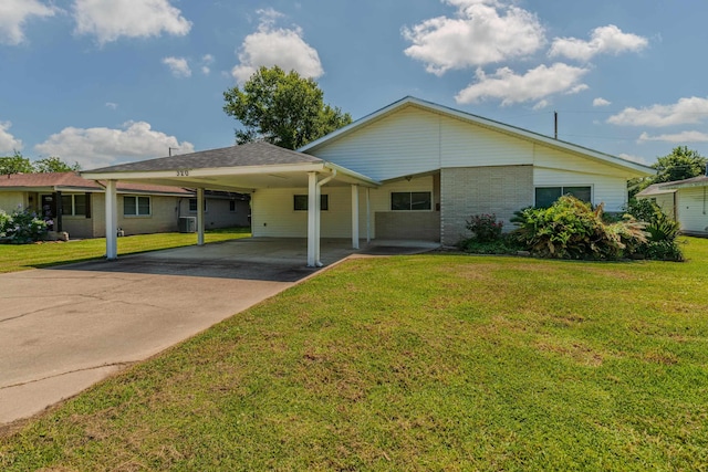 ranch-style home featuring a carport and a front yard