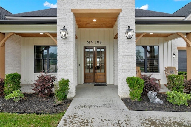 108 Palmetto Palm St, Lumberton, TX 77657 - doorway to property featuring a shingled roof, board and batten siding, covered porch, and french doors