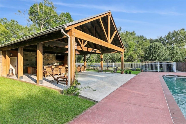 view of property's community featuring a gazebo, a patio, a lawn, and a swimming pool