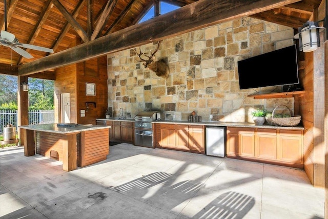 view of patio with area for grilling, ceiling fan, and sink